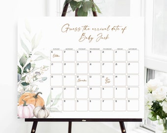 Op de afbeelding: Een wit bord op een ezel met de tekst "Raad de aankomstdatum van Baby Jack". Het heeft een kalenderraster met pompoenen en bloemaccenten. De kalender bevat de maanden oktober en november.