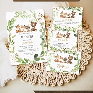 May include: A woodland-themed baby shower invitation with a green leafy border and a cute illustration of a deer, fox, raccoon, and bear. The invitation includes the text "Please join us for a baby shower honoring Carmen Jones".
