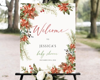May include: A welcome sign for a baby shower, featuring a floral design with red poinsettias, pinecones, and greenery. The sign reads "Welcome to Jessica's baby shower" with the date December 30th, 2024.