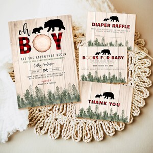 May include: A rustic baby shower invitation with a red and black plaid pattern, featuring a silhouette of a mama bear and two cubs. The text reads "Oh Boy! Let the Adventure Begin." The invitation includes details for the shower, including the date, time, location, and RSVP information.