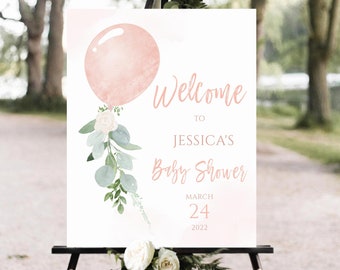 May include: A welcome sign for a baby shower with a pink balloon and floral accents. The sign reads "Welcome to Jessica's Baby Shower March 24, 2022".