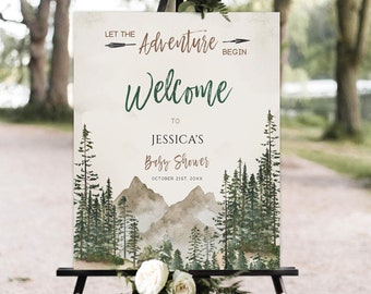 Peut inclure: Une pancarte de bienvenue pour une fête prénatale avec une illustration aquarelle d'une chaîne de montagnes et de pins. Le texte indique "Let the Adventure Begin" et "Welcome to Jessica's Baby Shower, October 21st, 20XX".