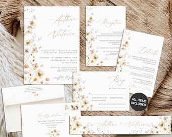 Op de afbeelding: Een set huwelijksuitnodigingskaarten met een bloemenontwerp. De kaarten zijn wit met een aquarelbloemenrand en de tekst "Arthur + Victoria" in gouden schrift. De kaarten bevatten een uitnodiging, een RSVP-kaart, een detailkaart en een ontvangstkaart.