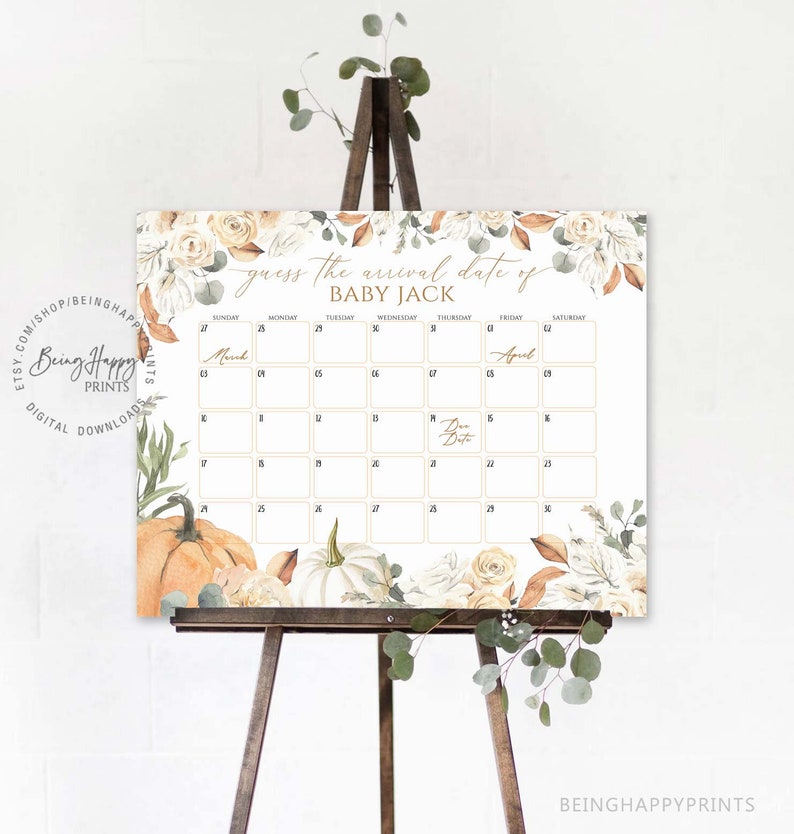 May include: A baby shower calendar sign on a wooden easel. The sign features the text "Guess the arrival date of BABY JACK" with a calendar grid. Floral and pumpkin illustrations decorate the edges. The sign is white with gold and brown accents.