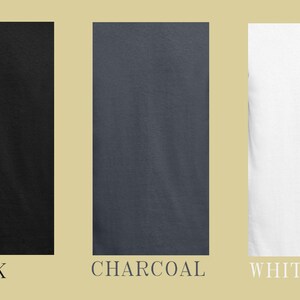 May include: Three plain t-shirts in black, charcoal, and white.