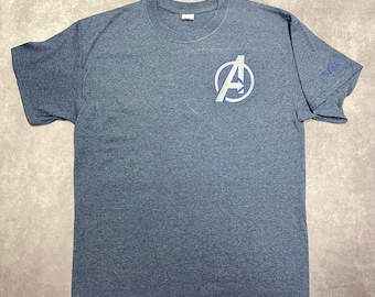 May include: A dark grey t-shirt with a white Avengers logo on the front and the word "Together" on the right sleeve.