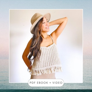 May include: A white crochet top with a fringe hem and a V-neckline. The model is wearing a beige hat and has long brown hair. The text "PDF EBOOK + VIDEO" is at the bottom of the image.