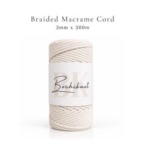 May include: A spool of off-white braided macrame cord measuring 3mm x 300m. The spool features a white paper label with the text Braided Macrame Cord 3mm x 300m at the top and the brand name Bochiknot printed in black script over a large BK.