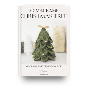 May include: A book cover with the title "3D Macrame Christmas Tree". The image features a handmade green macrame Christmas tree adorned with gold star-shaped embellishments and a gold ribbon. A spool of beige yarn is visible in the background.
