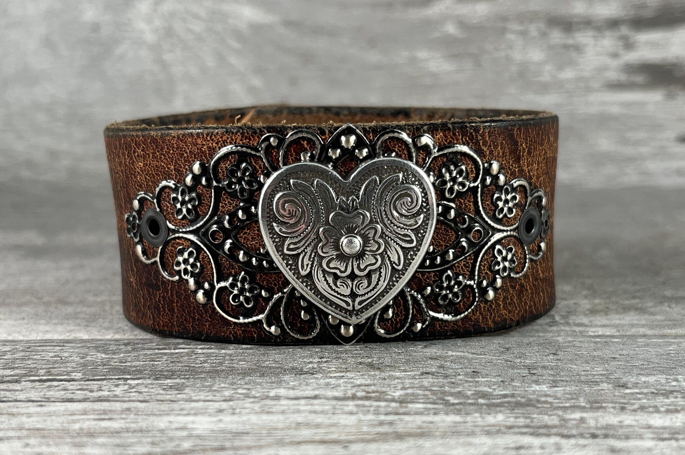 Brown leather cuff bracelet with silver tone heart concho