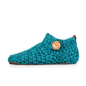 Side angle of a teal blue wool slipper with wooden button fastening and suede leather sole. Handmade by Kingdom of Wow. Barefoot design for Men and Women.