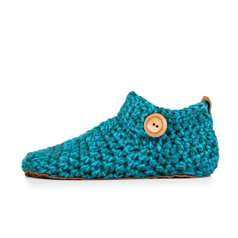 Side angle of a teal blue wool slipper with wooden button fastening and suede leather sole. Handmade by Kingdom of Wow. Barefoot design for Men and Women.
