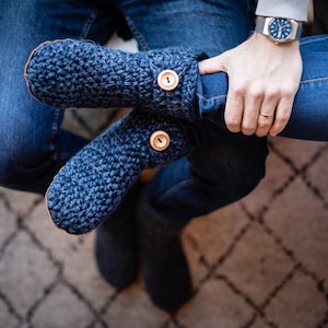 Woman wearing handmade wool boot slippers with wooden button fastening and suede leather soles. Barefoot design. Large sizes available up to US Men's 14 EU 49. Indoor shoes that are warm, comfortable and cozy