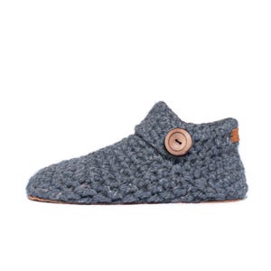 Side angle of a dark gray wool slipper with wooden button fastening and suede leather sole. Handmade by Kingdom of Wow. Barefoot design for Men and Women.