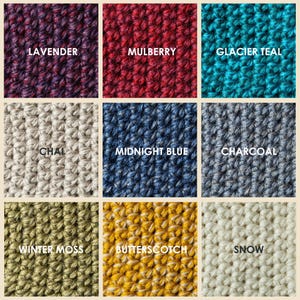 Nine squares of crocheted fabric in various colors. The colors include lavender purple, mulberry red, glacier teal, chai beige, midnight blue, charcoal gray, winter moss, butterscotch yellow, and white snow. Each square has the color name printed on it. Color options for Kingdom of Wow wool slippers.