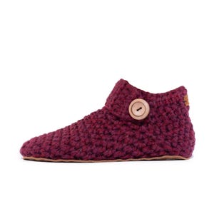 Side angle of a burgundy red wool slipper with wooden button fastening and suede leather sole. Handmade by Kingdom of Wow. Barefoot design for Men and Women.