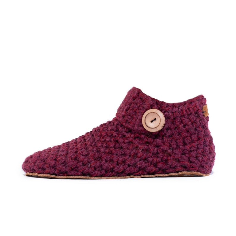 Side angle of a burgundy red wool slipper with wooden button fastening and suede leather sole. Handmade by Kingdom of Wow. Barefoot design for Men and Women.
