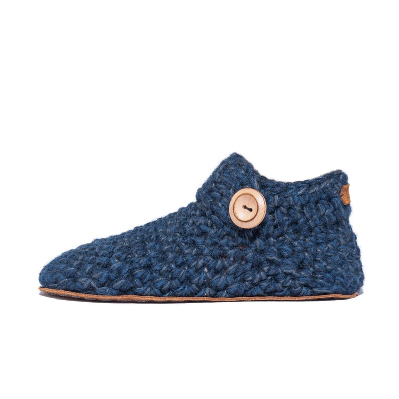 Side angle of a navy blue wool slipper with wooden button fastening and suede leather sole. Handmade by Kingdom of Wow. Barefoot design for Men and Women.
