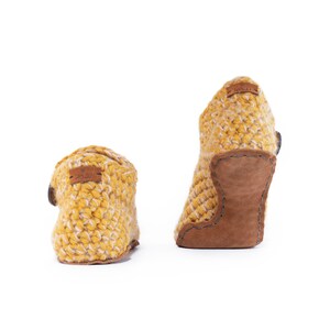 Back view of a pair of yellow wool slippers with wooden button fastening and suede leather sole. Handmade by Kingdom of Wow. Barefoot design for Men and Women.