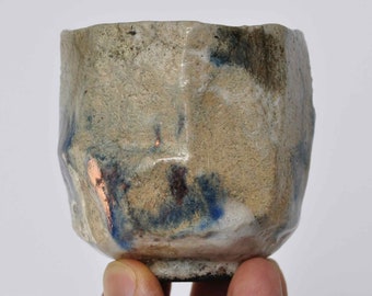 Asymmetric white-blue chawan. A distinct crackle effect and copper luster.  Raku pottery.