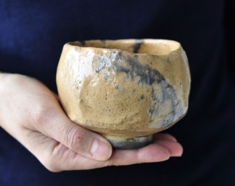 Big chawan with blue fish. Mustard yellow with dark-blue smears.  Raku pottery. Tea bowl.