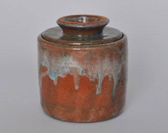 Brown French butter dish with white smears and blue and green glints. Raku pottery.