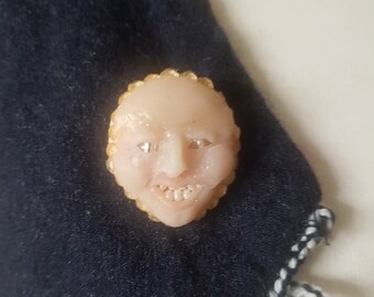 doll head brooch a strange face ugly and cute