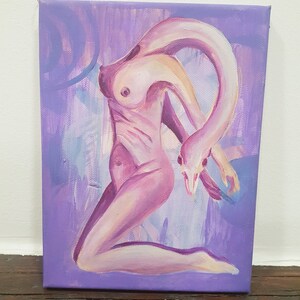 May include: An original painting on canvas depicts a nude figure with a swan-like form. The artwork features a palette of pinks and purples, with the figure's body blending into a soft, abstract background. The painting is mounted on a wooden frame.
