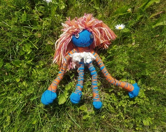 a strange and cute baby girl doll with button eyes