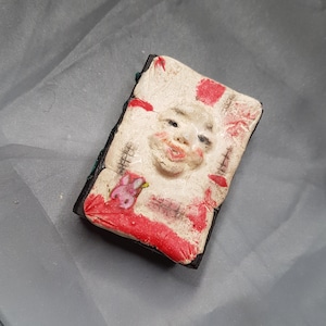 haunted book fleshy with black pages ugly and cute