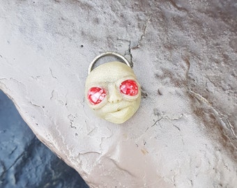 ugly and sweet , alien pendant with big red eyes
