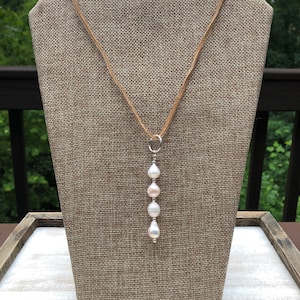 Leather and Pearl Necklace with Silver ring and freshwater pearls .