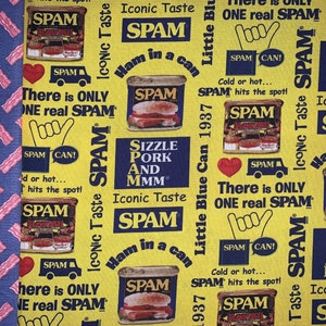 May include: A yellow fabric with a repeating pattern of Spam luncheon meat cans and the text "Iconic Taste Spam" and "There is only one real Spam".