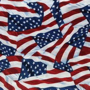 May include: A seamless pattern of red, white, and blue American flags. The flags are arranged in a chaotic pattern, with some overlapping and some flying in the wind. The background is a light blue.