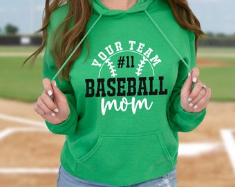 May include: Green hooded sweatshirt with the text "Your Team #11 Baseball Mom" in white and black lettering. The text is inside a circle with a baseball graphic.