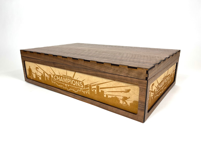 Silhouetted characters and scenes from the Marvel Champions living Card game laser engraved on an MDF storage box