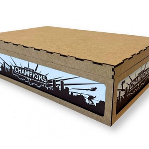 May include: A brown cardboard box with a cutout window showing a black and white graphic of a city skyline with the text "Marvel Champions" on a white background.