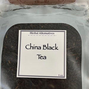 May include: A clear glass jar with a cork lid filled with loose leaf black tea. The label reads "Herbal Alternatives" and "China Black Tea" with a 1 oz. measurement.