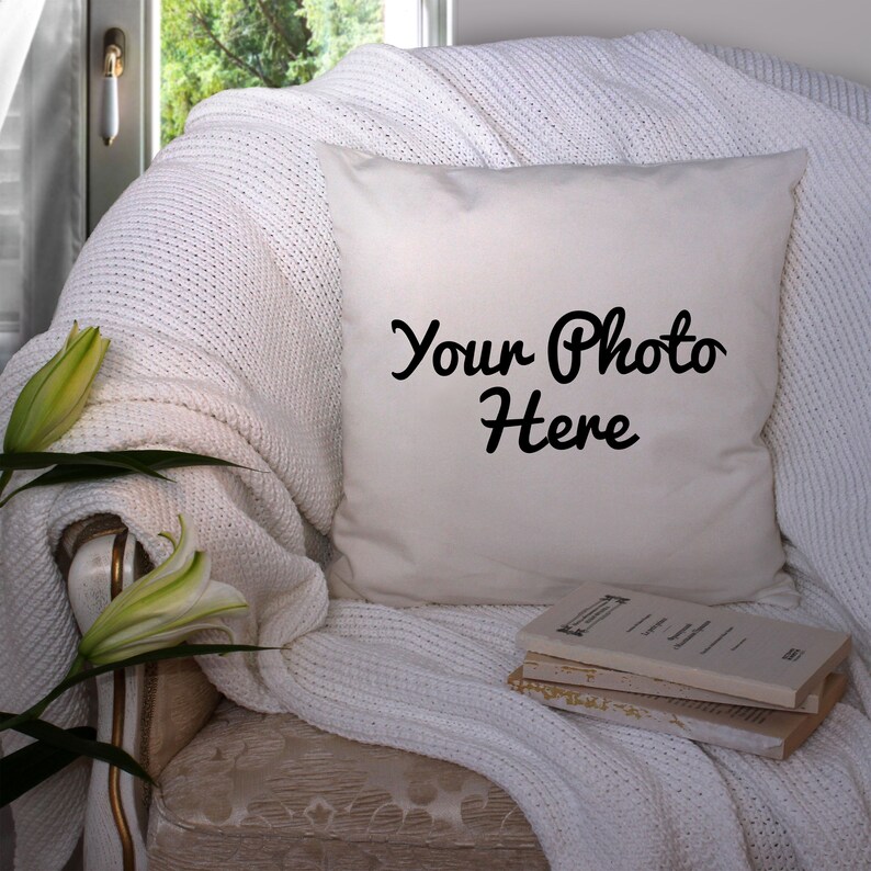 May include: A white throw pillow with the text "Your Photo Here" in black cursive font. The pillow is on a white armchair with a white throw blanket and a stack of books.