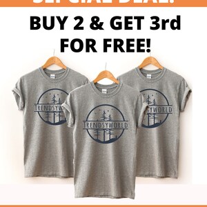 May include: Three gray t-shirts with a forest scene and the text "TRENDSYWORLD" printed on the front. The image includes the text "SEPCIAL DEAL! BUY 2 & GET 3rd FOR FREE!" and "USE COUPON CODE: SPECIAL3".