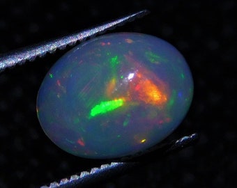 50/% discount on 0.60 ct Ethiopian welo opal.. Fire opal CABOCHON... 8x6 mm