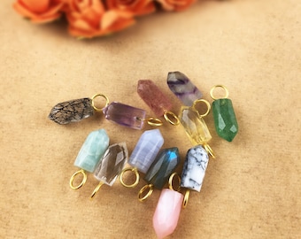 May include: Assortment of 10 gemstone point pendants with gold jump rings. The gemstones include amethyst, rose quartz, clear quartz, green aventurine, blue lace agate, labradorite, and black tourmaline.