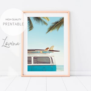 May include: A blue vintage van with a surfboard on the roof, parked on a beach with palm trees in the background.