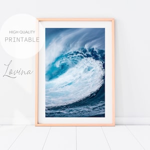 May include: A photograph of a large ocean wave crashing in the water. The wave is a bright blue and white color, with a dark blue background. The wave is framed in a light wood frame.