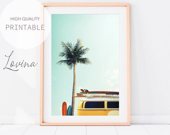 May include: A yellow vintage van with surfboards on the roof parked in front of a palm tree against a blue sky.