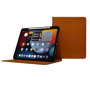 May include: A brown leather case for an iPad with a black screen displaying the iPad home screen. The case is folded to prop the iPad up at an angle.