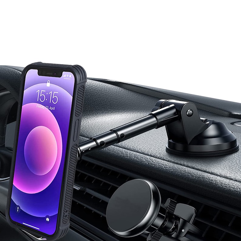 May include: A black car phone mount with a suction cup base and adjustable arm, holding a smartphone with a black case. The phone displays the time 15:15 and the date Friday, April 23.