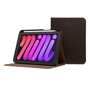 May include: A brown leather case for a tablet with a black screen and a white stylus. The case is folded open and the tablet is visible. The tablet screen shows a colorful abstract design with the word "Milli" on it.