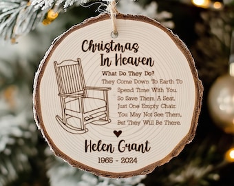 May include: A wooden Christmas ornament with a rocking chair and the text "Christmas in Heaven. What Do They Do? They Come Down To Earth To Spend Time With You. So Save Them A Seat, Just One Empty Chair. You May Not See Them, But They Will Be There."  The ornament also includes the name "Helen Grant" and the dates "1965-2024".