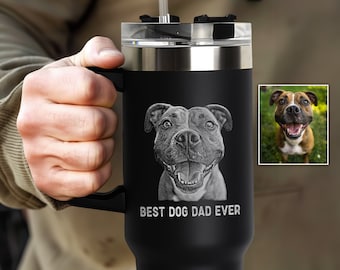 May include: Black stainless steel travel mug with a handle and a straw. The mug has an engraved image of a dog and the text "BEST DOG DAD EVER".